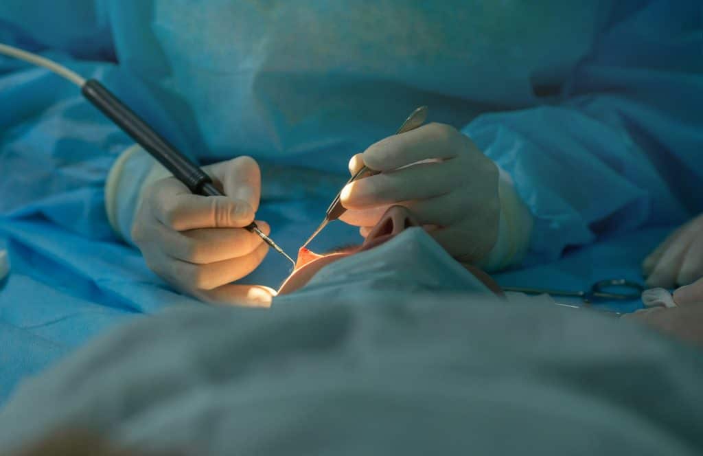 ophthalmologist performs an operation on the patient's eye.