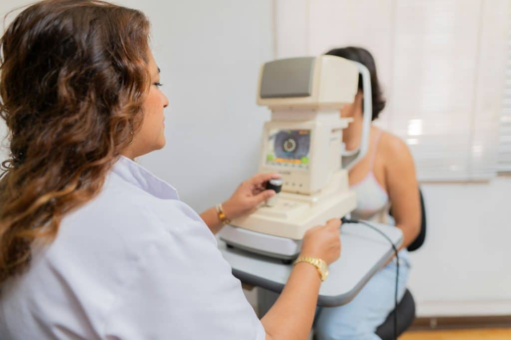 Ophthalmologist using a machine to exam the vision of patient