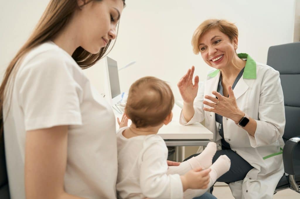 Young mom and child at pediatric ophthalmologist consultation