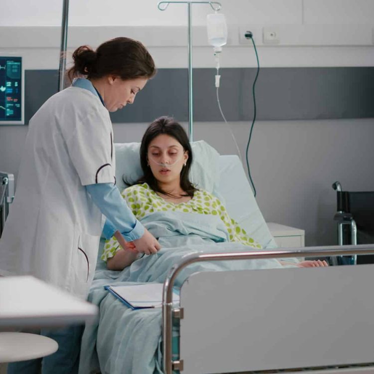 Practitioner specialist checking hospitalized sick woman resting in bed